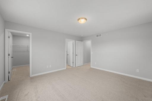 Owners bedroom spacious and tons of wall space of furniture placement