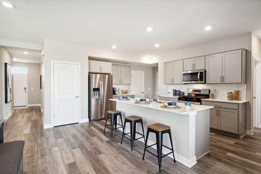 Abundant cabinet space, large kitchen island and pantry space make this kitchen a highlight of the Elm. *Picture is of model home; actual finishes may vary.