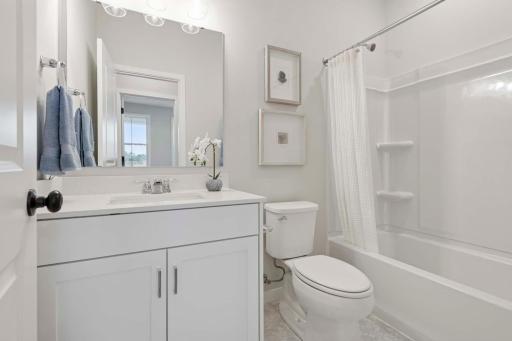The hall bath,conveniently located directly across from the secondary bedroom, is both functional & stylish. The tub/shower combination provides versatility for quick showers or bath. Photos are of previously built home; options & features will vary.