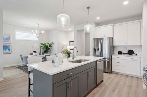 View from kitchen into casual dining space. Photos are of previously built home; options & features will vary.