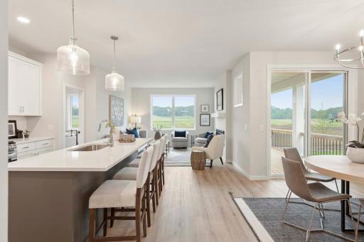 Perfectly placed windows and a sliding glass door fill the home with natural light, creating a bright and welcoming atmosphere throughout the day. Photos are of previously built home; options & features will vary.