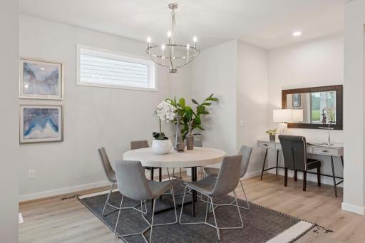 The casual dining room is a warm, inviting space designed for everyday meals & relaxed gatherings. Open to the kitchen & living area, it encourages connection & conversation. Photos are of previously built home; options & features will vary.