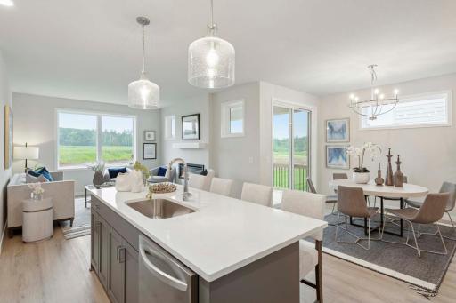 Perfectly placed windows and a sliding glass door fill the home with natural light, creating a bright and welcoming atmosphere throughout the day. Photos are of previously built home; options & features will vary.