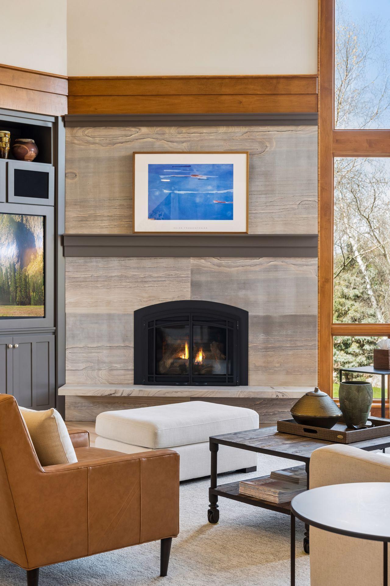 Custom designed Brentwood slab stone fireplace is a showpiece and creates a warm inviting space.