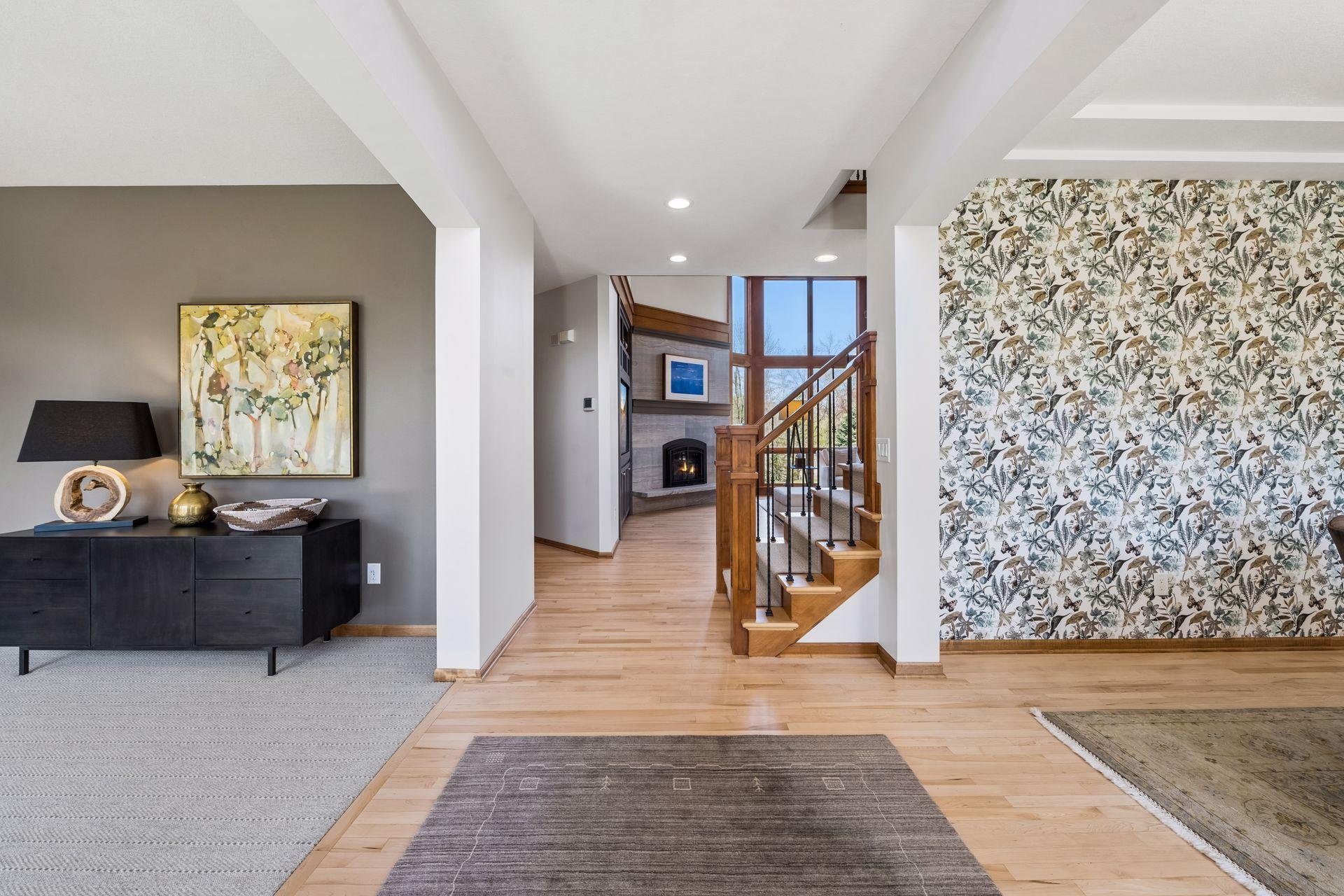 Entryway looking in at custom staircase, railings. Curated finishes in dining room and a comfy bonus/flex room - grand piano? 2nd office? your need is it's definition.