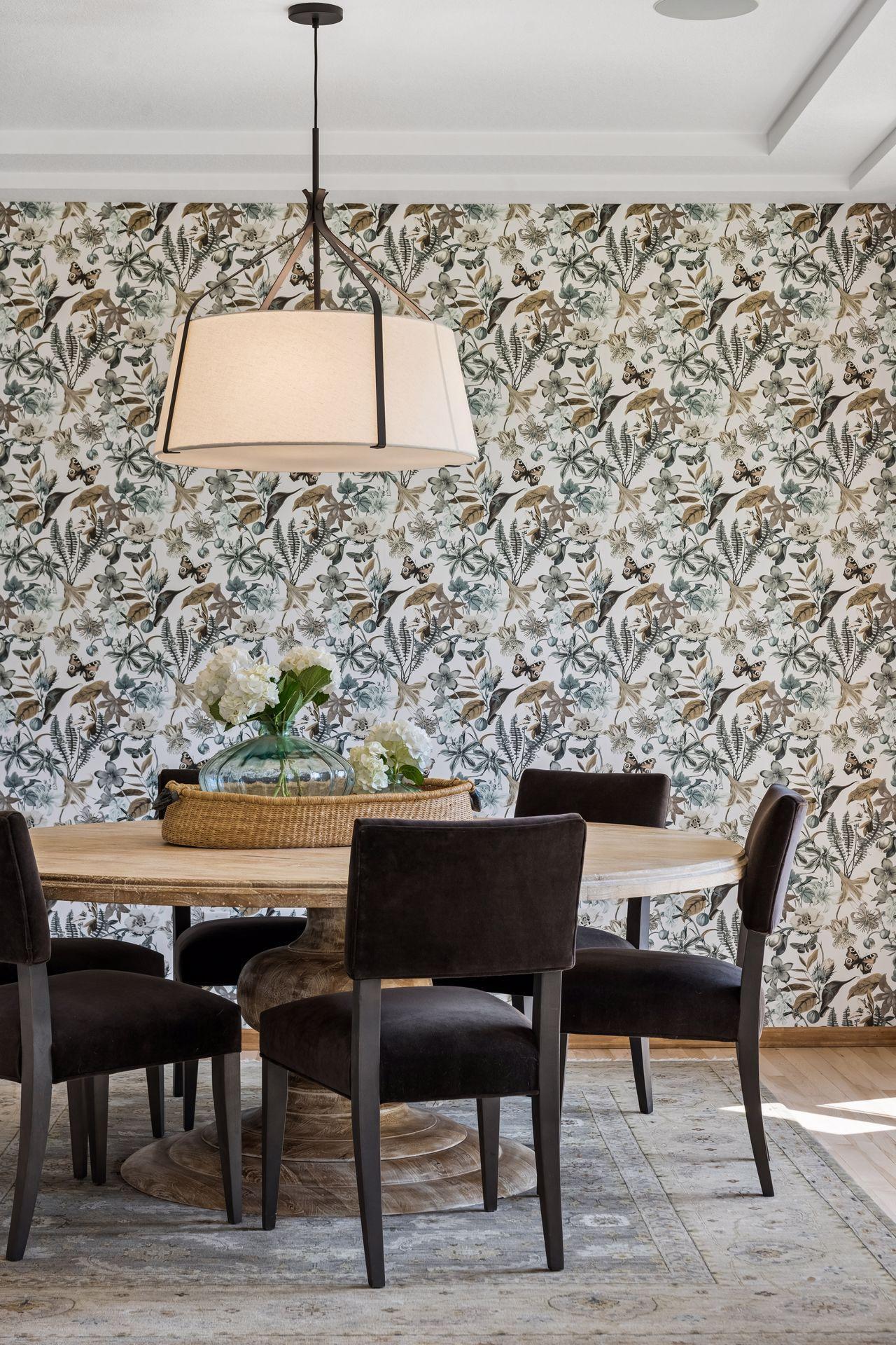 Dining room with hand-selected lighting fixture and accent wall-covering.