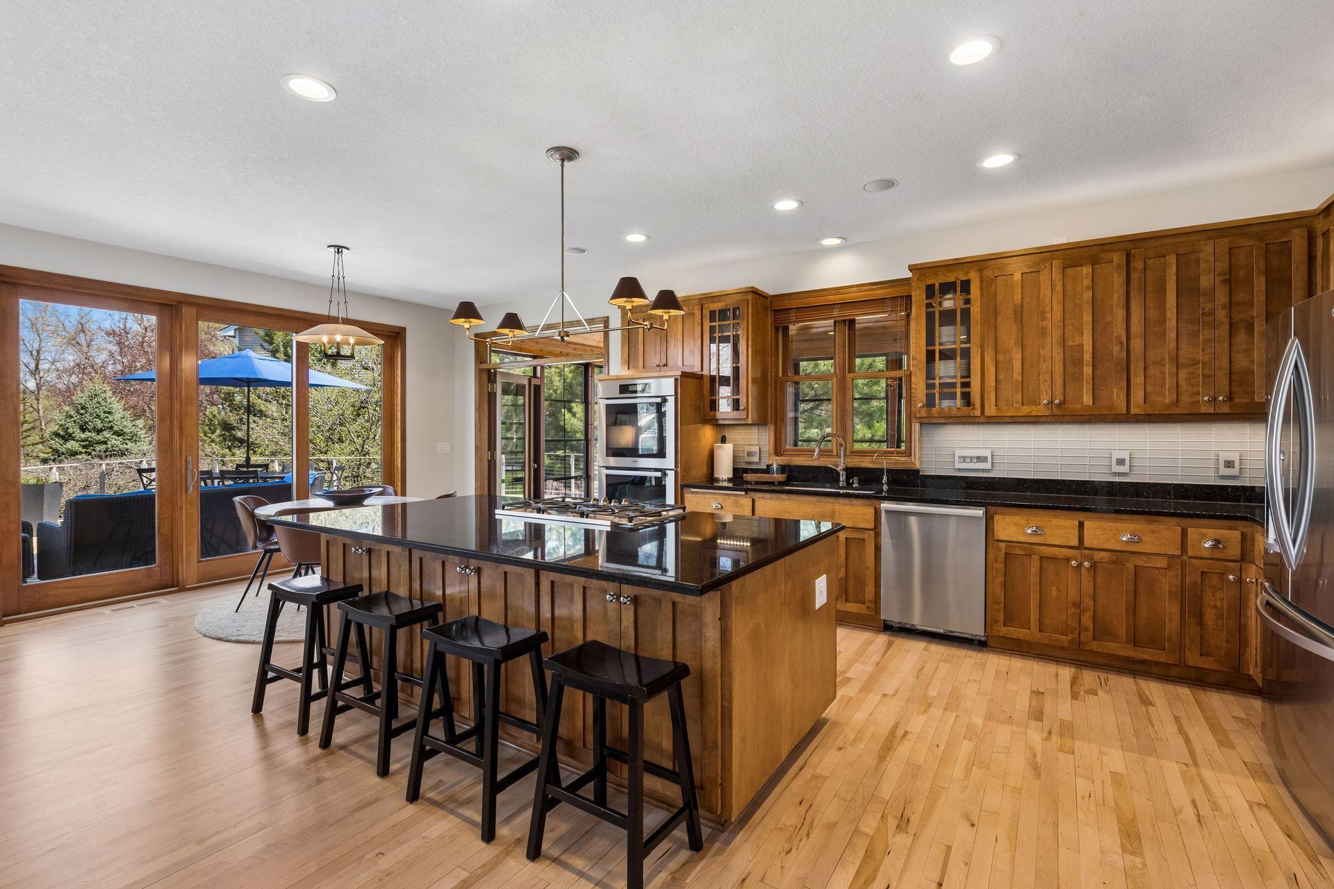 Chef's kitchen with double ovens, gas cooktop on double deep granite topped island.