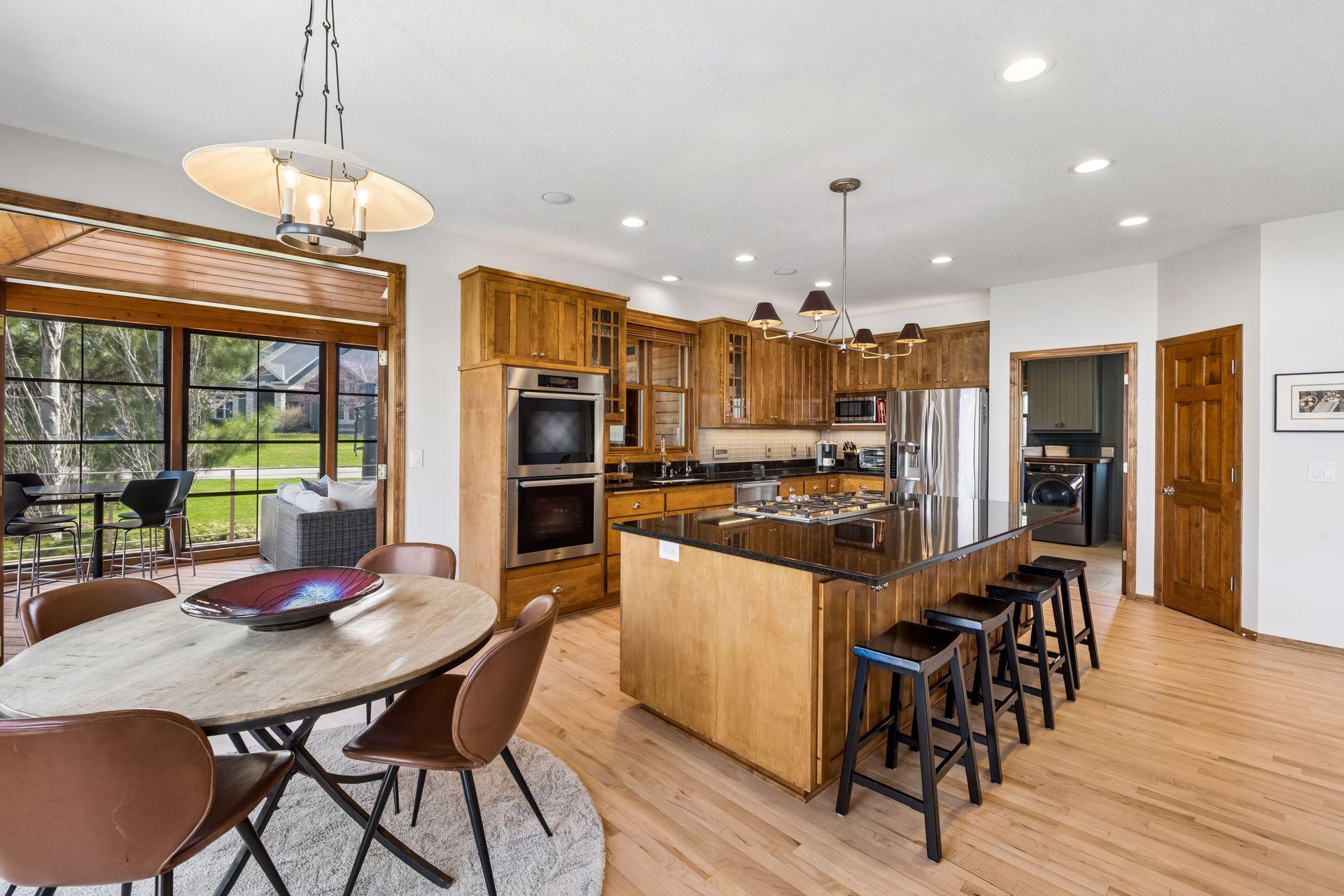 Informal dining space open to kitchen and leads to 3 season porch.
