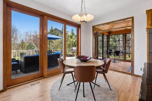 Informal dining opens to fabulous outdoor spaces - expansive deck to the left, porch to the right. Enjoy all the seasons.