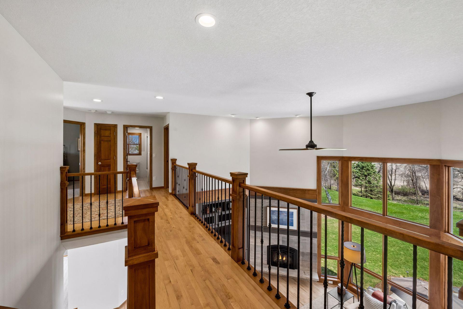 Maple hardwood floors, custom spindles and rails. Walkway keeps the primary suite close but private.