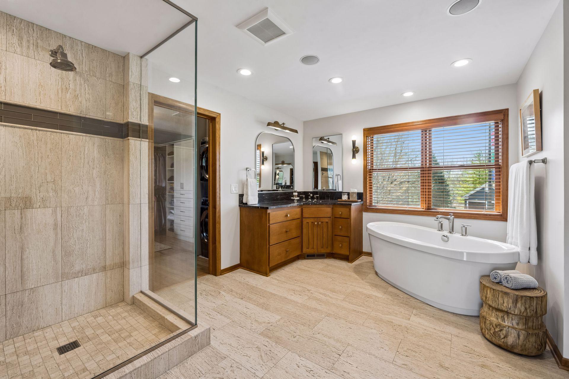 Incredible spa-like bath with heated tile floors, glass and stacked tile shower surround. Dual yet separate vanities topped with granite, embellished with polished nickel fixtures, new lighting, mirrors plus a glorious deep soaking tub.