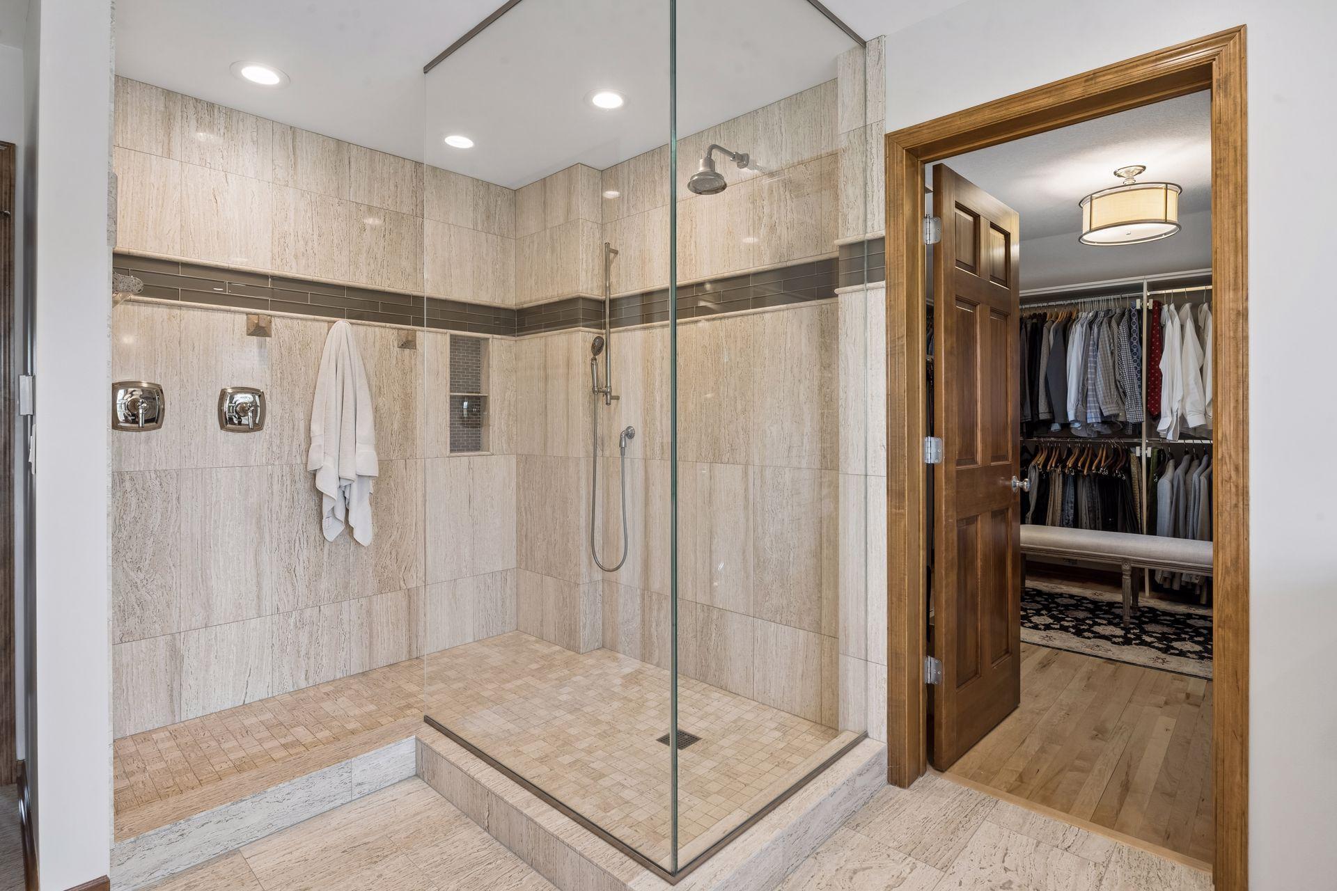 Primary bath leads to custom walk-in closet.
