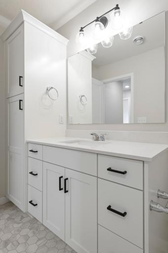 Convenient lower-level bath with generous storage and linen space.