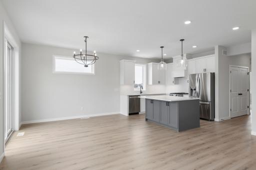 Kitchen highlights include a large center island and a sink perfectly positioned under a window.