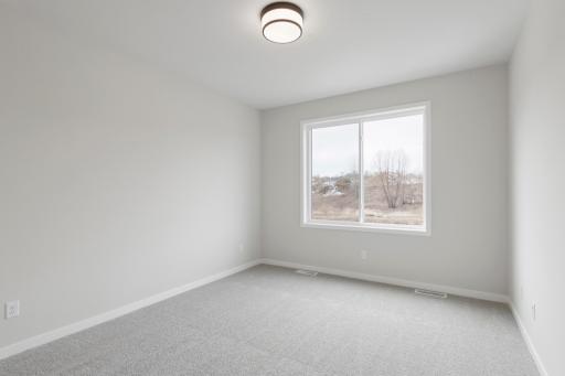 Desirable main-level primary bedroom offering comfort and accessibility.