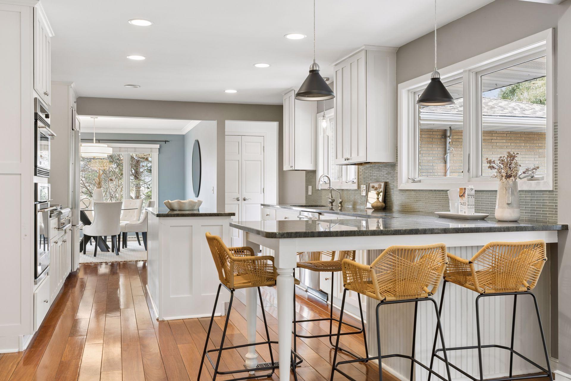 Bright gourmet kitchen with a center island, stainless steel appliances, and a peninsula for casual dining.