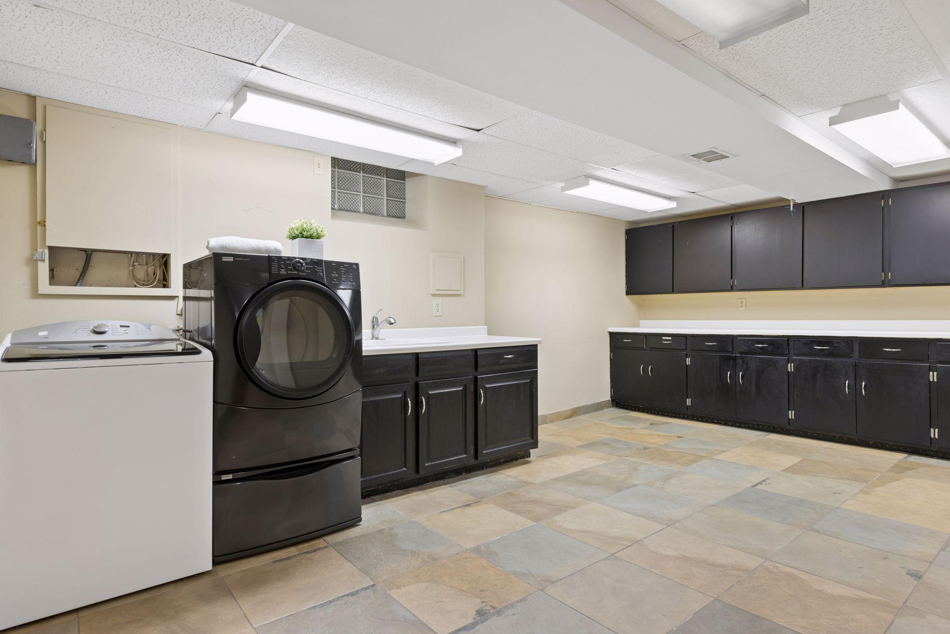Gigantic laundry room with washer/dryer & lots of cabinets for extra storage.
