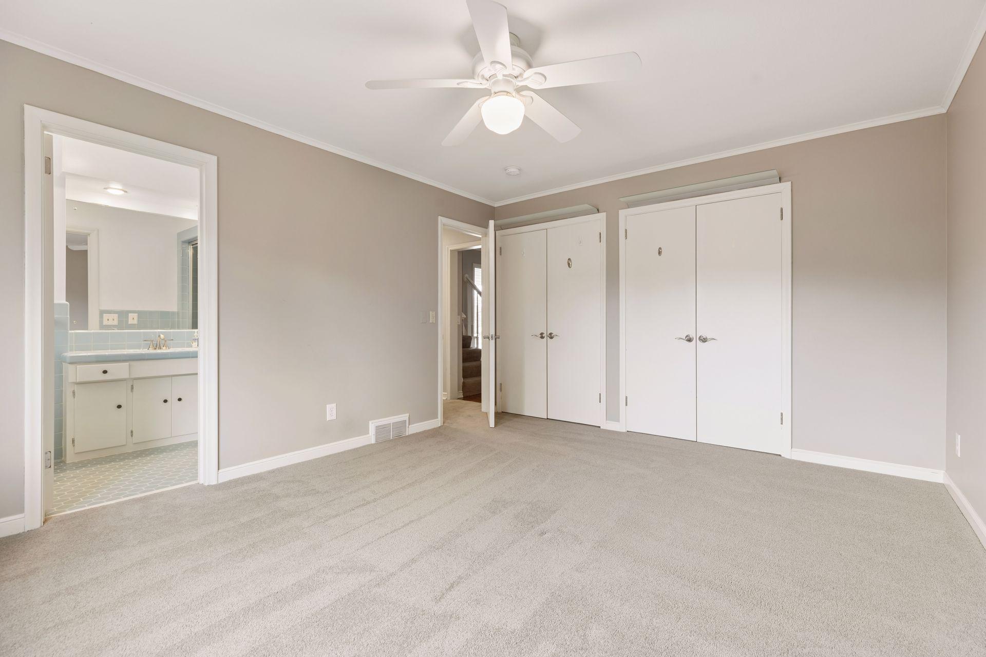 Bedroom #2 on the main level offers an ensuite 3/4 bathroom with a fun pop of color!