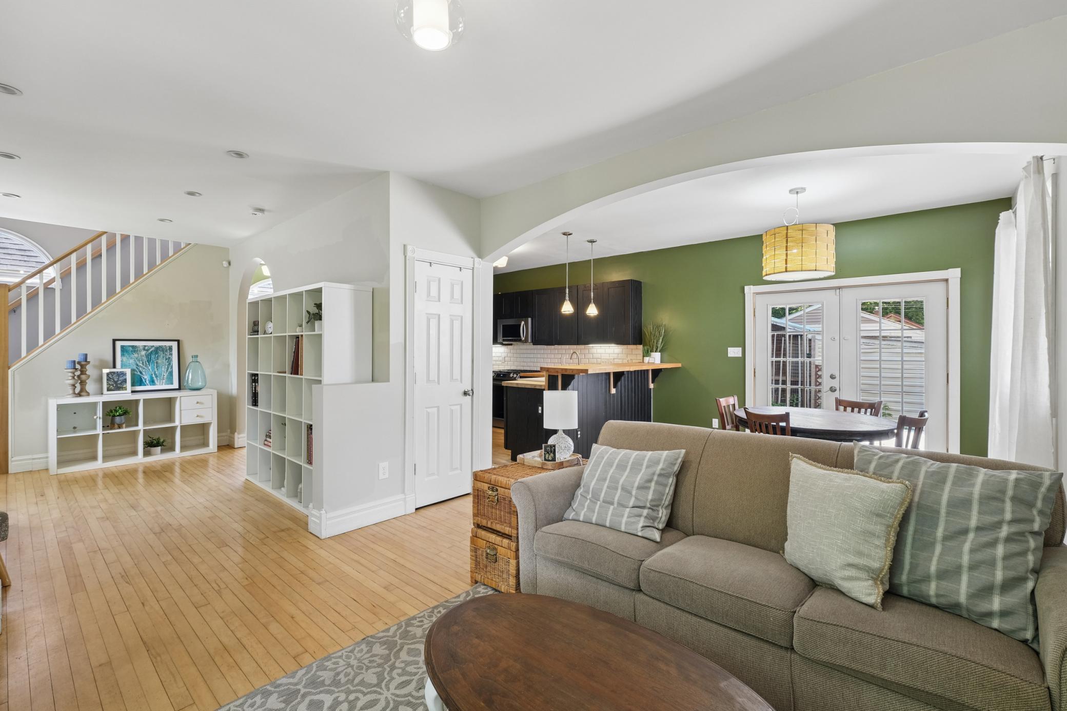 Large living area with an open floorplan and original hardwood flooring