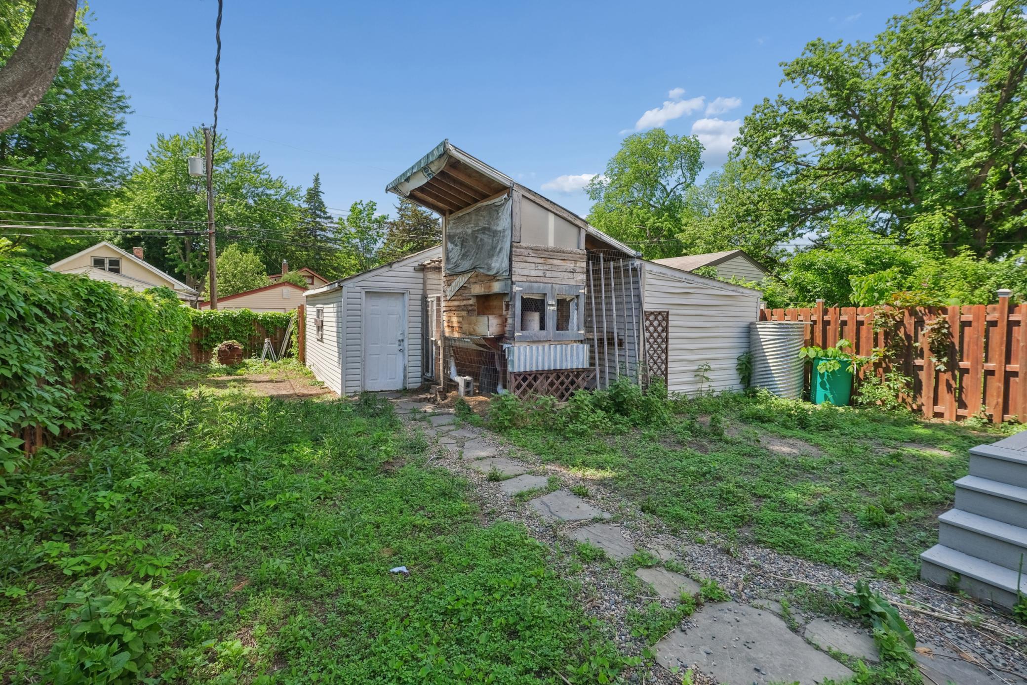 The urban chicken coop adds a unique touch of city homesteading and character to the outdoor space.