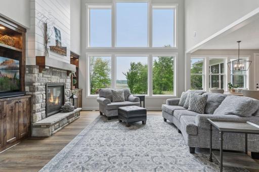 Expansive windows, including soaring two-story panes, flood the interior with natural light and frame uninterrupted views of the protected Carlos Avery Wildlife Area.