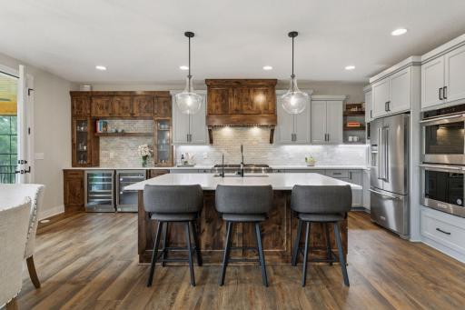 Cook, gather, and unwind in a chefâs kitchen complete with a 6-burner range, expansive island, built-in bar, and a bright breakfast nook encircled by windows.