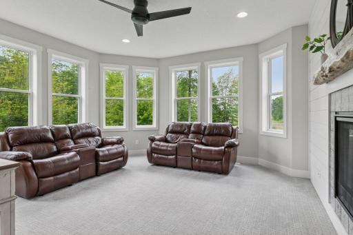 Also off the front entry, a spacious office provides a quiet place to work, while further inside, this cozy hearth roomâsharing a double-sided fireplace with the living roomâoffers a welcoming space for reading, crafts, or quiet moments.
