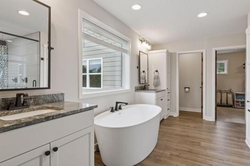 A spa-like bath featuring a dual-head walk-in shower, soaking tub, and dual vanities for a truly luxurious start and end to each day.