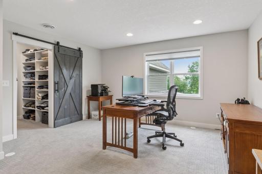This connected flex room, located just off the closet, is currently used as a home office and offers endless potential for work, wellness, or relaxation.