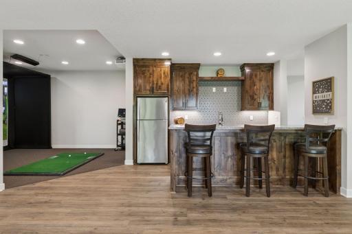 The full wet bar features a double-sided islandâideal for casual conversations, game nights, or serving guests in style.