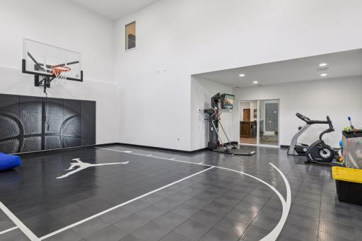 A large indoor gym with a basketball hoop, specialized flooring, and a dedicated exercise zone offers year-round recreation for all ages.