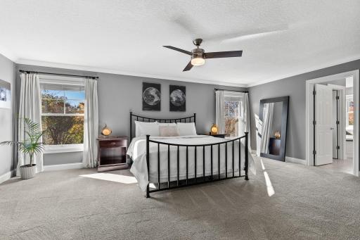 Spacious light filled primary suite featuring ensuite bath and walk in closet.