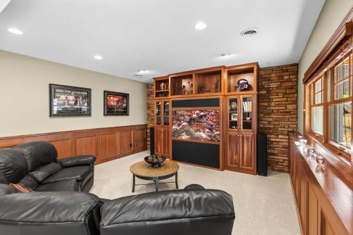 Lower level media room with custom cabinets, large entertainment center and look out windows. Perfect for watching the big game or hosting movie night.