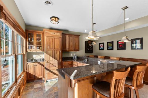Wet bar with Sub-Zero refrigerator.