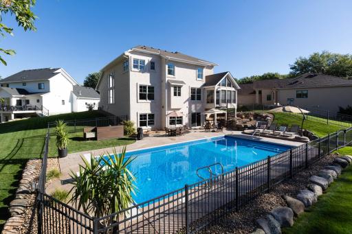 Beautifully landscaped backyard featuring fenced in, in ground swimming pool and access to Duck Lake.