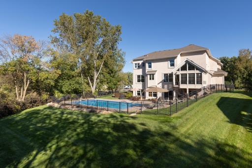 Gorgeous backyard setting with privacy, fenced yard, multiple outdoor living spaces, all surrounded by mature trees for a serene, resort like feel.