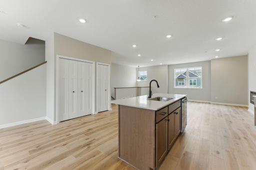 A large kitchen island makes meal prep and ease of conversations with people sitting at the islance.