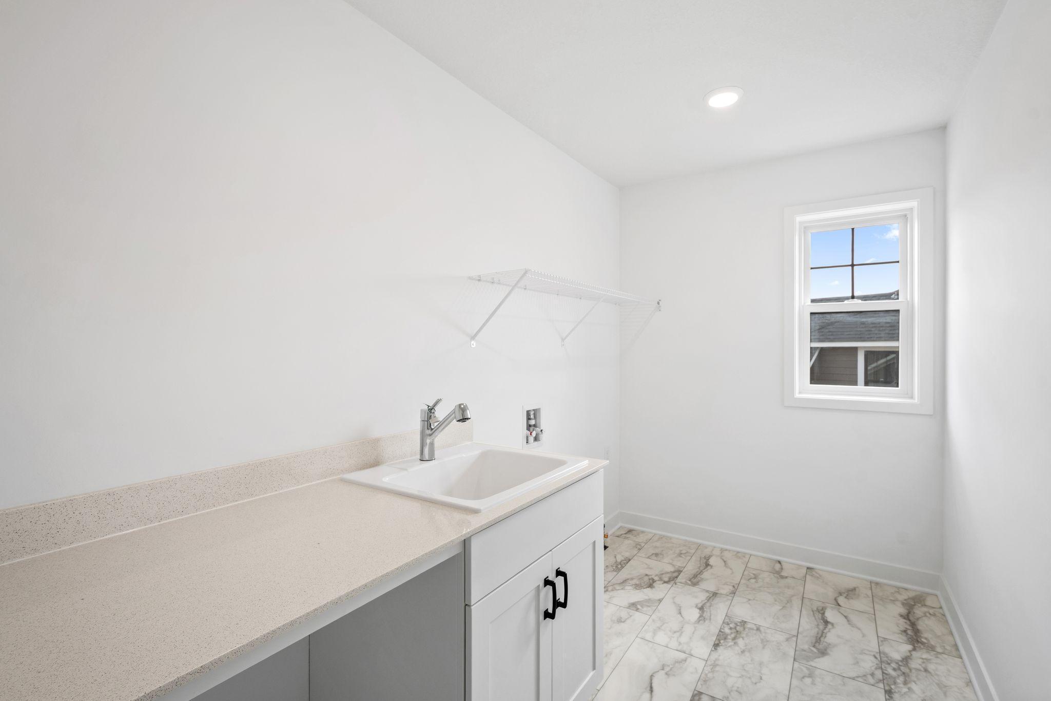 A convenient laundry room is located among the bedrooms on the top floor.