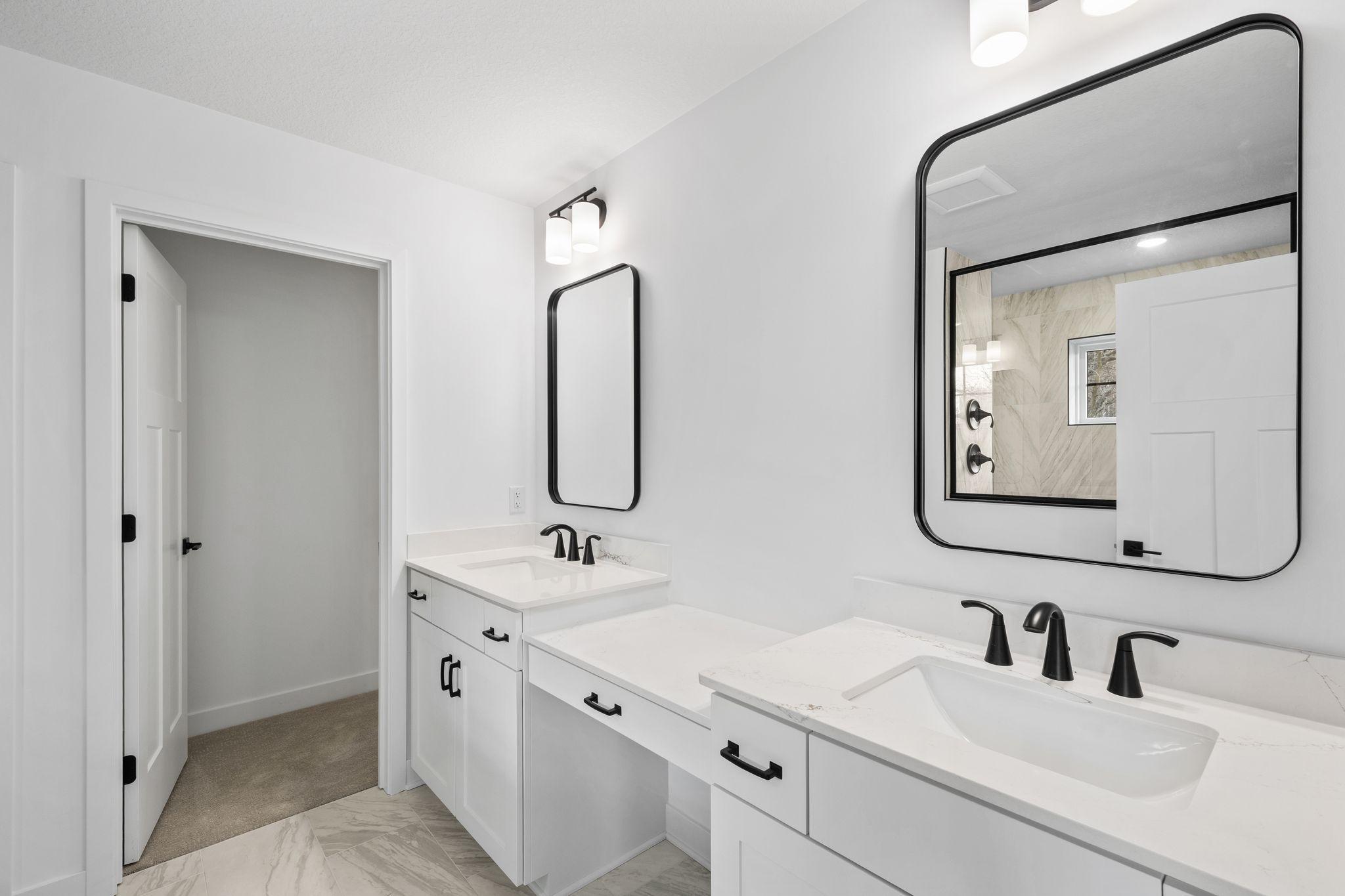 The bathroom is complete with dual sinks