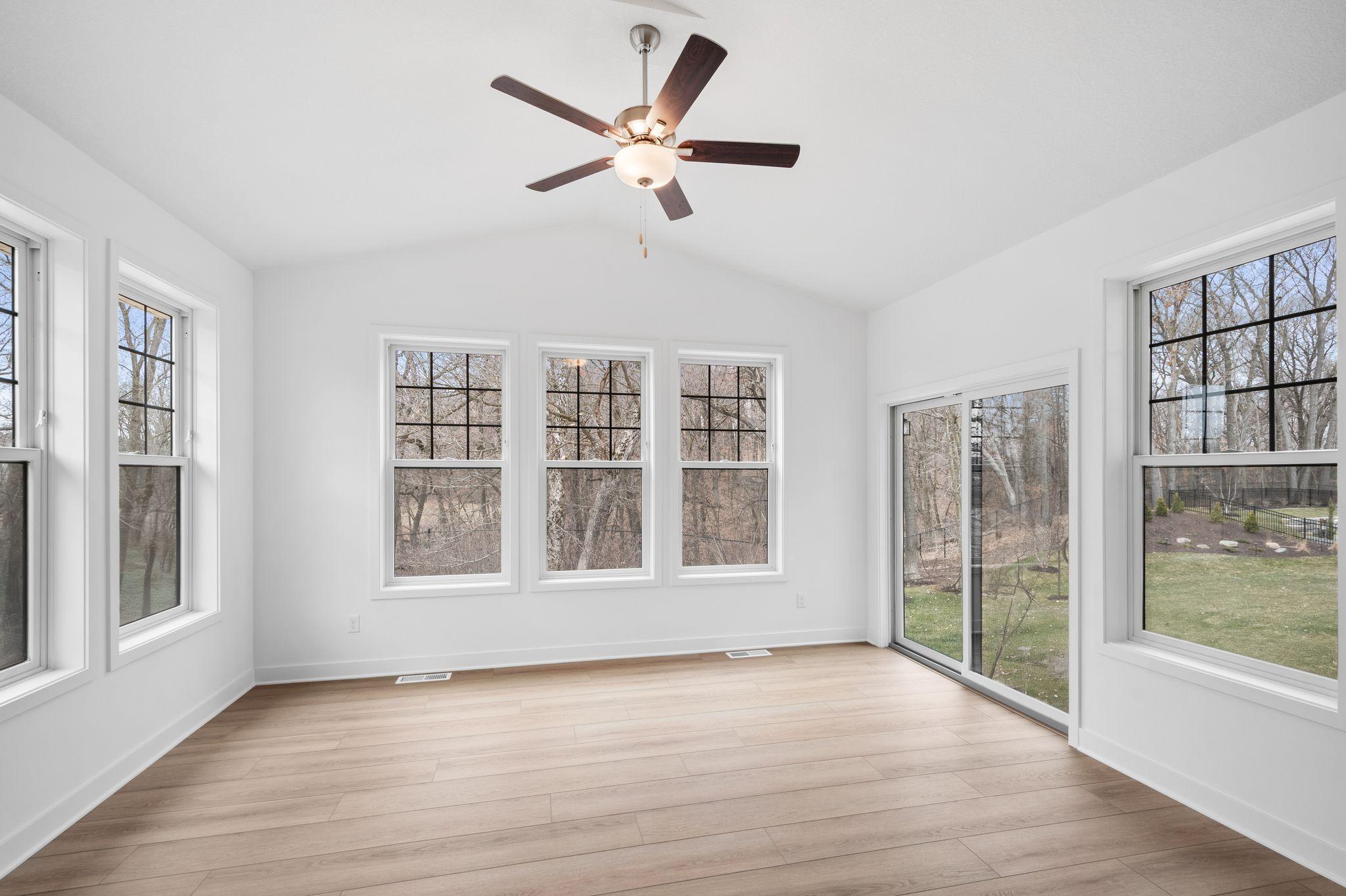 The porch offers abundant natural light with large windows and backyard access.