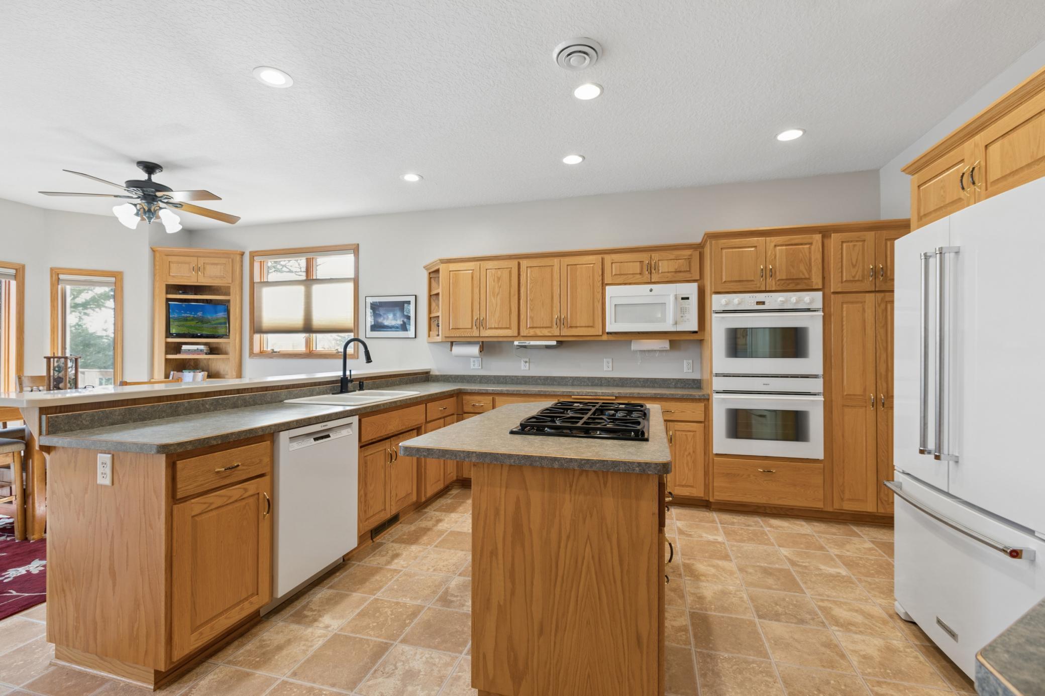 This kitchen not only offers plenty of storage and prep space but has plenty of natural light with the wall of windows lakeside.