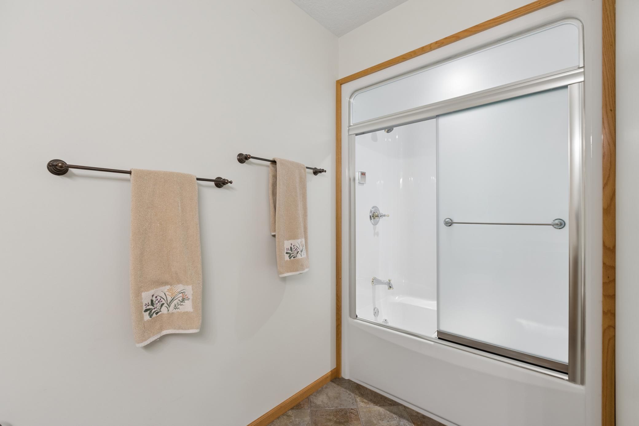 View of the tub with steam shower enclosure.