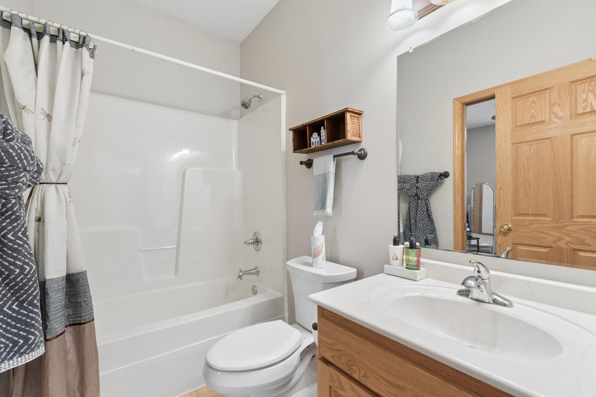 Connected to the second main floor bedroom is a full bathroom, conveniently located off the foyer and den.