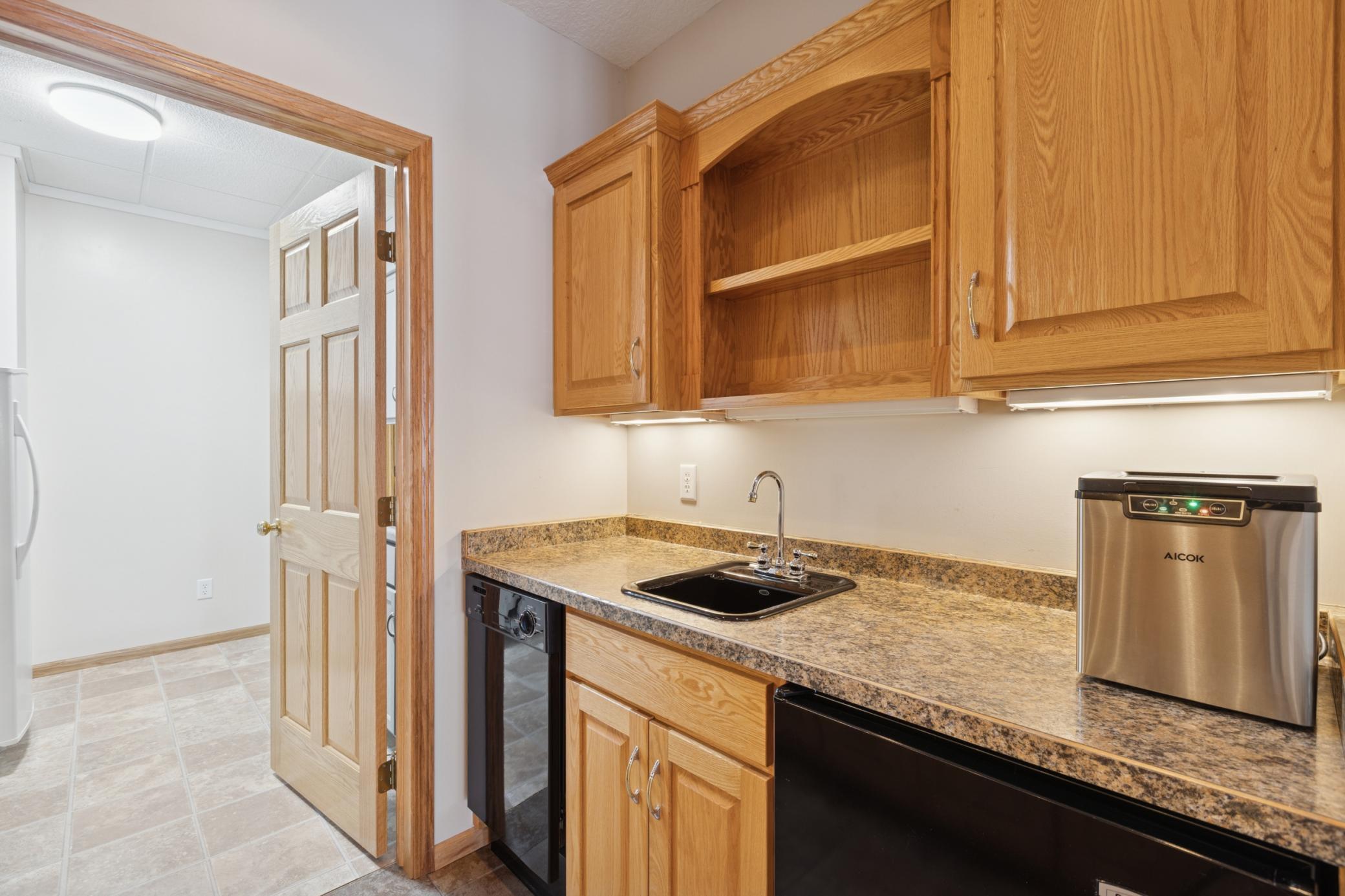 Just off the lower-level living room is a wet-bar complete with dishwasher and microwave. Perfect for entertaining and relaxing at the lake!