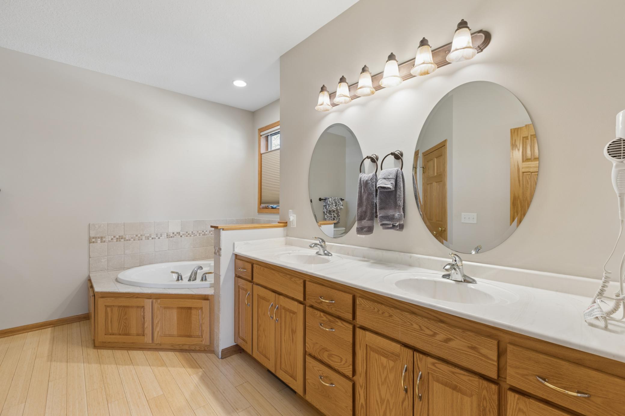 The private ensuite bathroom offers a dual sink vanity, jetted tub, a separate shower and a walk-in closet. Quality built homes like this are hard to find and do not come for sale often on premier lakes in the area.