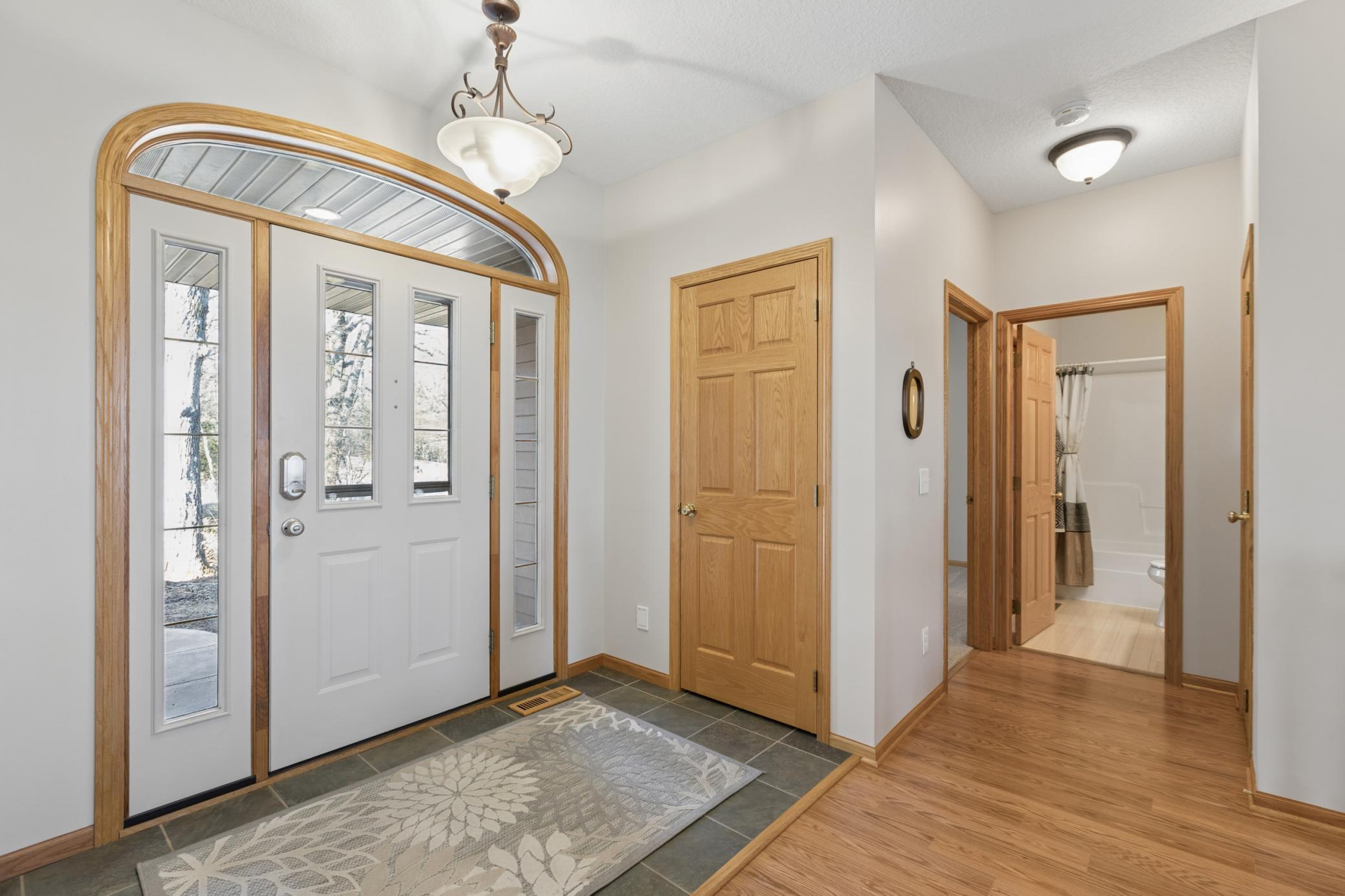 View of the entryway with dual closets on either side of the door and full bath along with guest room just down the hall. Schedule your private showing today!