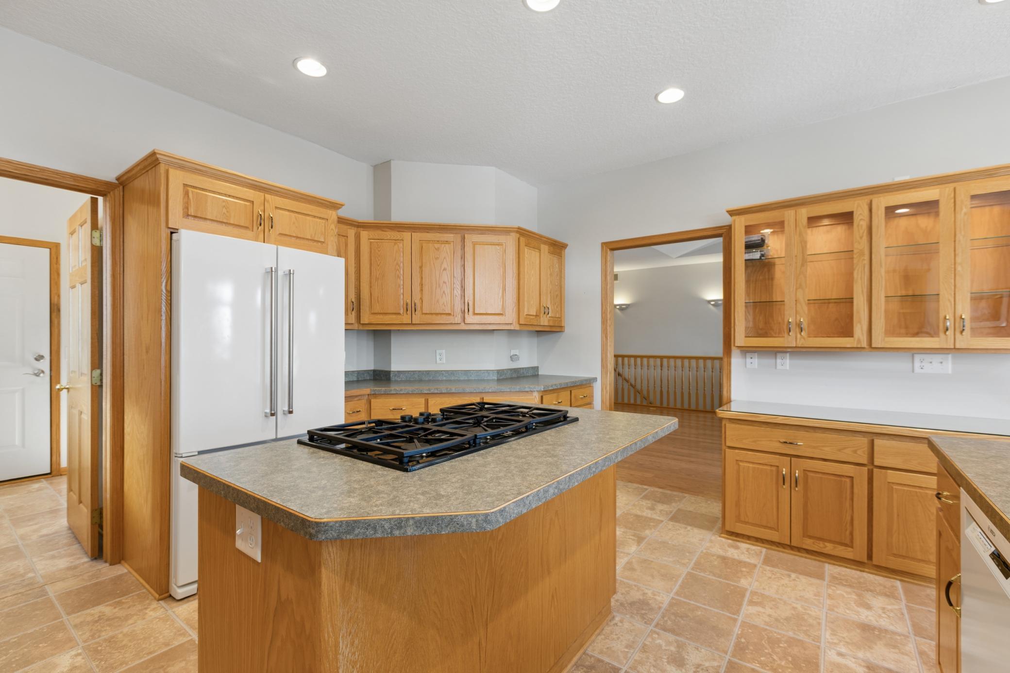 The gas cooktop is strategically placed within its own island for storage and underneath the kitchen exhaust system. Whether you are entertaining or preparing a routine meal you will appreciate your time spent in this kitchen.