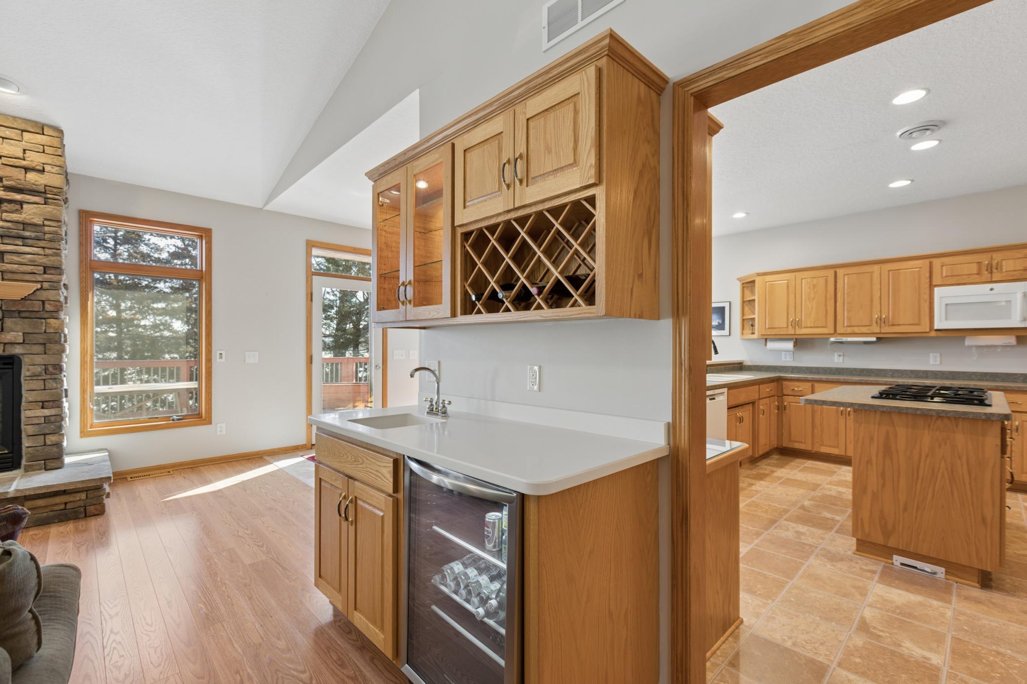 Accompanying the main floor den is a wet bar with built in wine rack and beverage fridge. This home is an entertainers dream on the shores of Cedar Lake.
