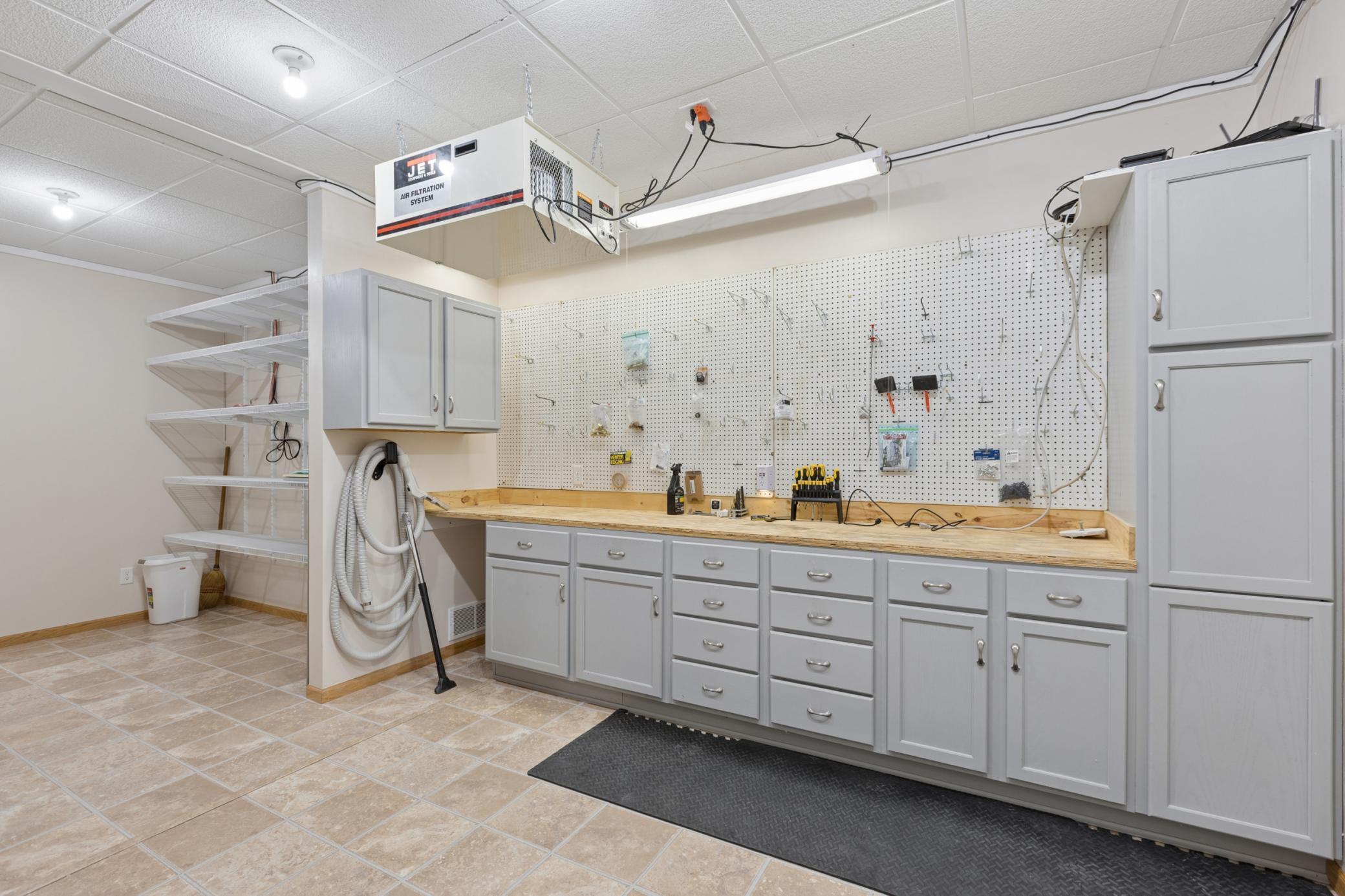 The lower level is complete with a workshop with plenty of storage and organization space.
