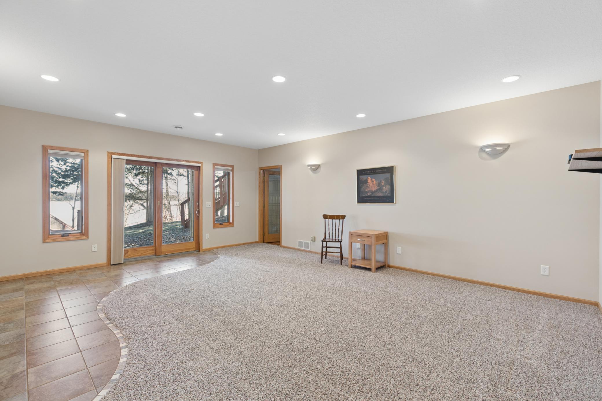The lower-level living room is ideal for relaxing or entertaining. Cedar Lake is located less than an hour from the Twin Cities and about a half hour from Saint Cloud.